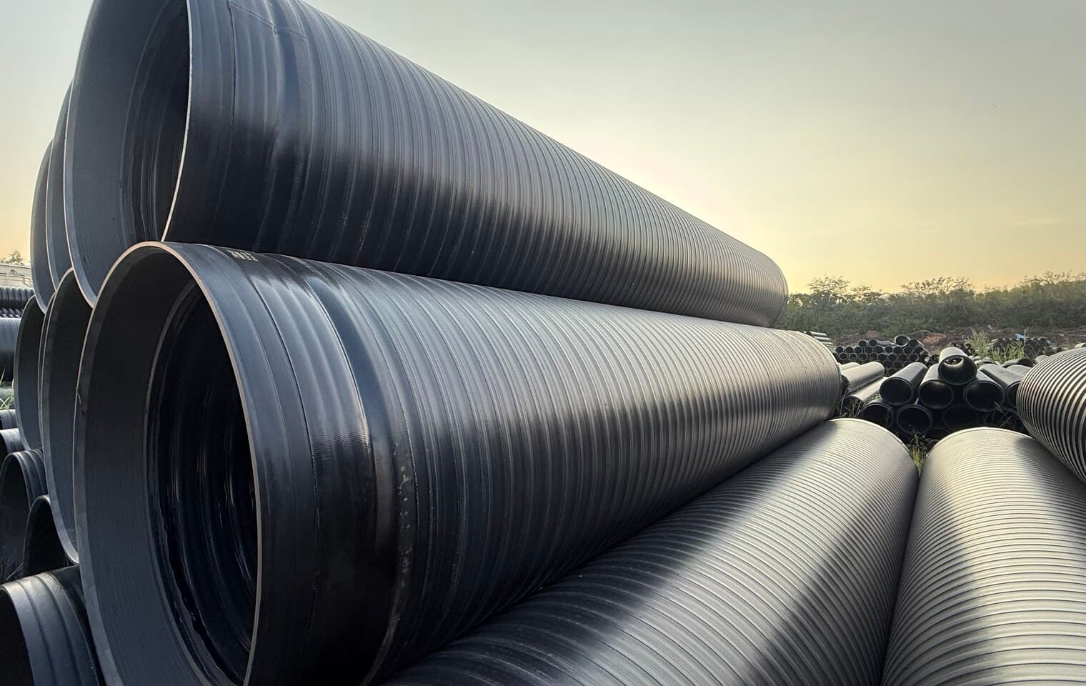 Rows of finished pipe held in the yard, the stock a project draws against