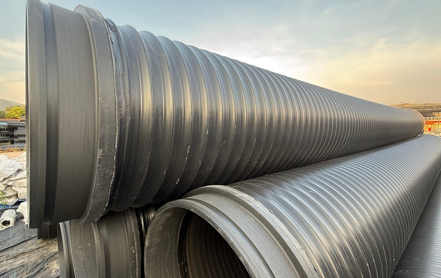 Blue and black PE pipe racked together, the small-diameter sizes used for course mains