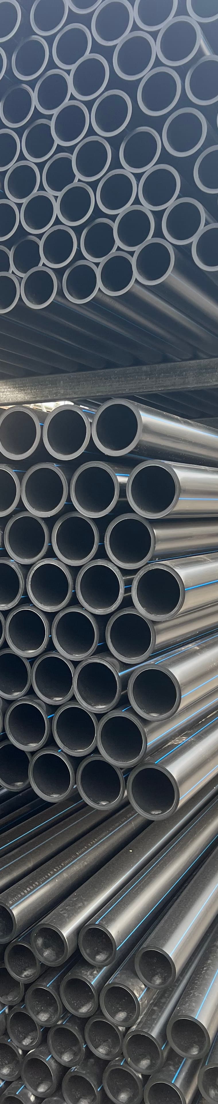 Thick-wall pipe stacked in the yard, built for abrasive tailings duty