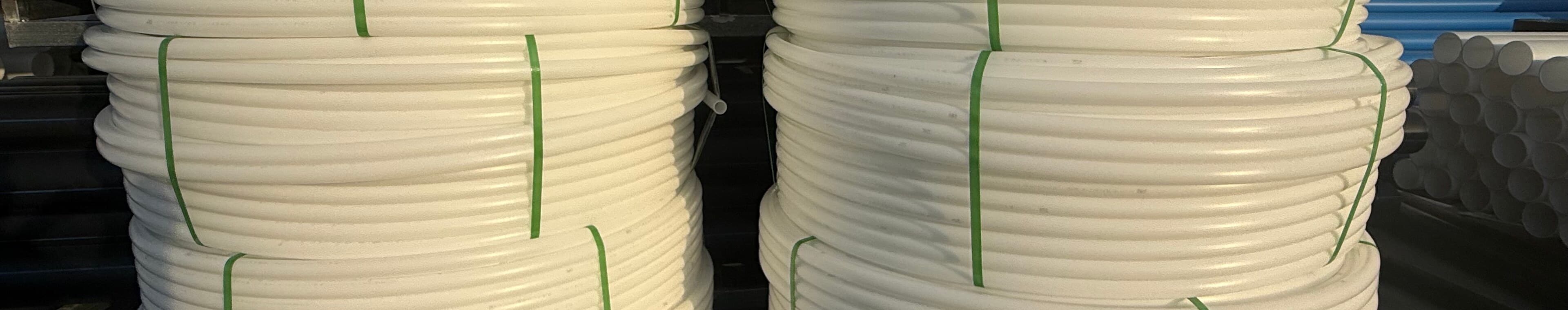 Large-diameter pipe stacked in the yard for cooling water duty