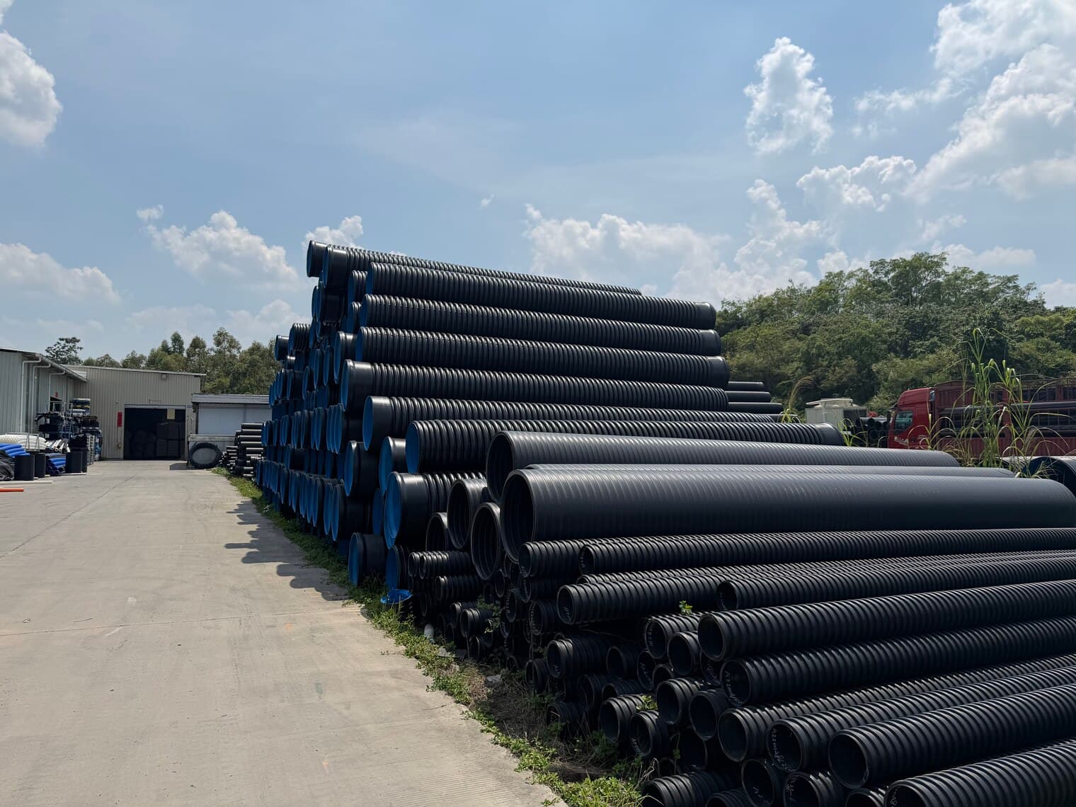 Bundles of corrugated pipe separated by diameter, ready for order picking