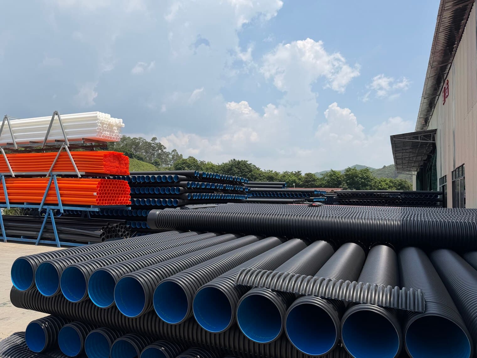 The drainage range side by side — corrugated sewer pipe, solid wall and orange conduit