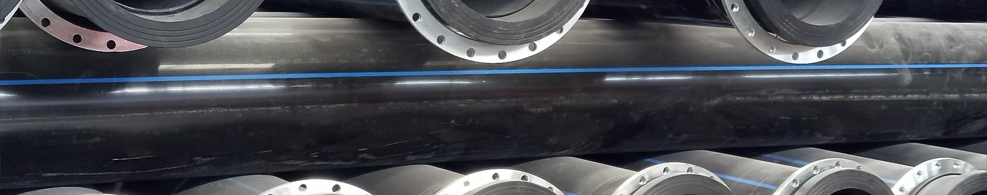 DN500 dredging pipe with flanged ends stacked in rows under the shed roof