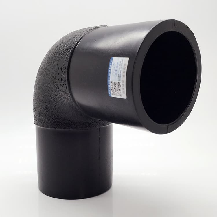 A 90° elbow upright, carrying the batch label that ships with every fitting