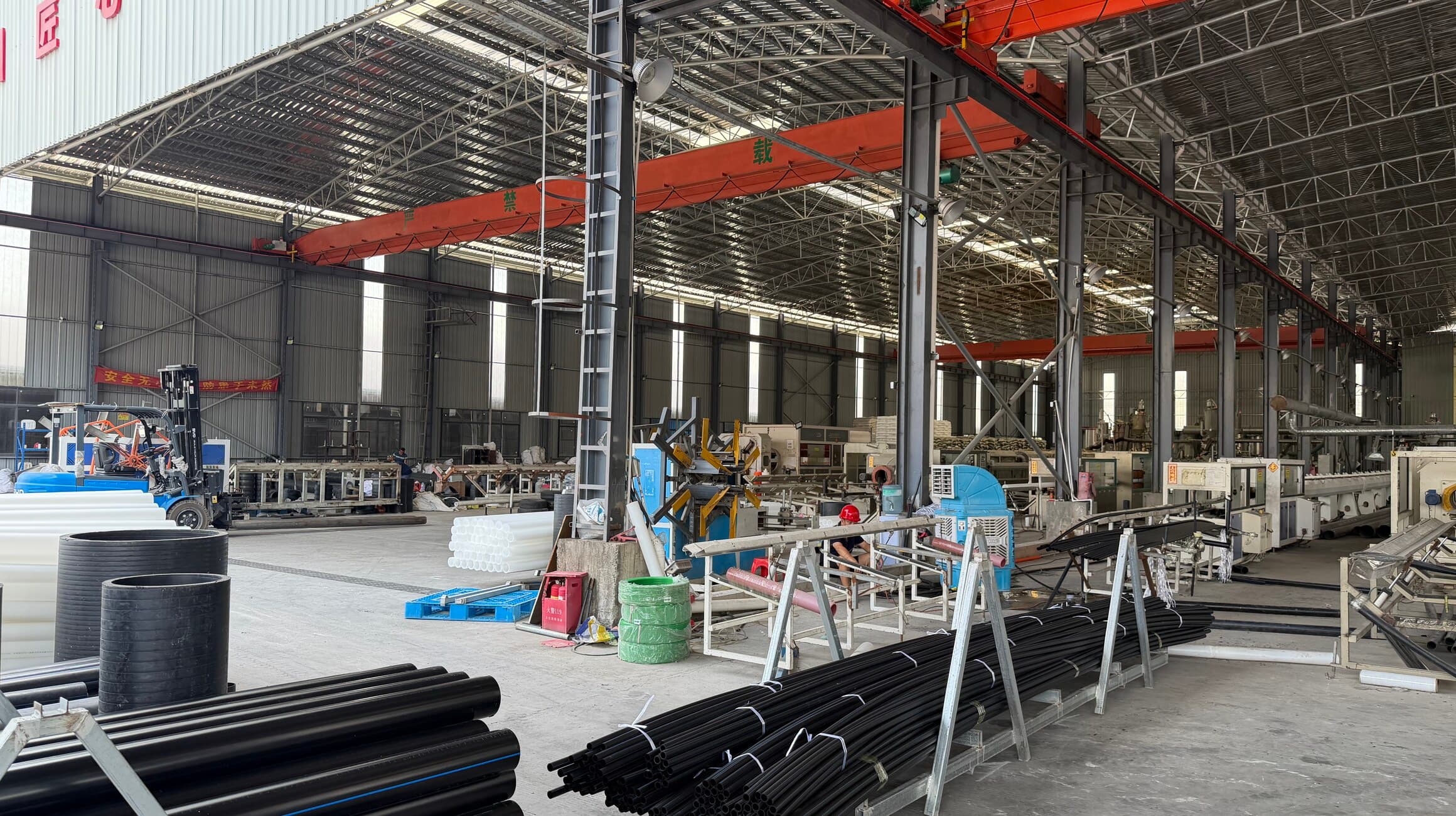 Finished pipe and work in progress stacked between the lines on the shop floor