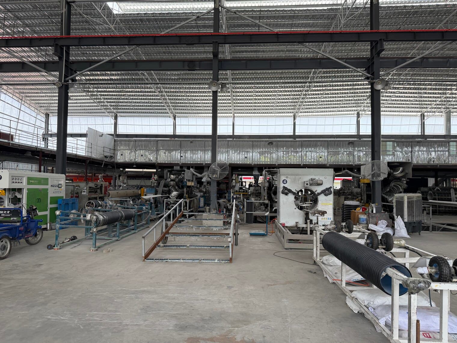 A row of extrusion lines with their haul-off units and downstream equipment