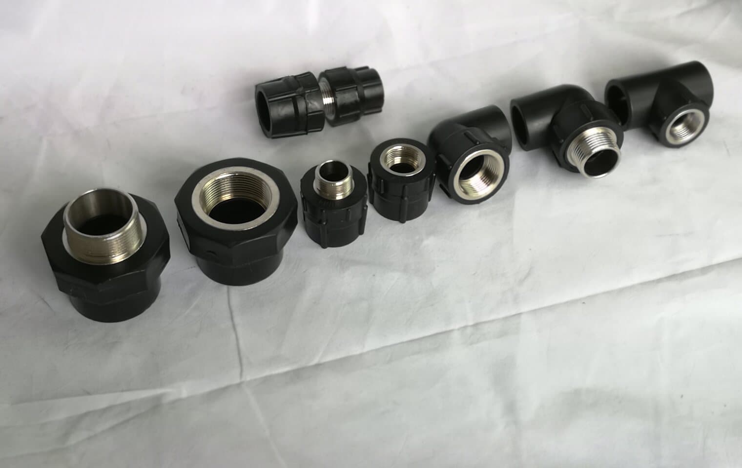 Small-bore PE fittings and couplers set out in size order