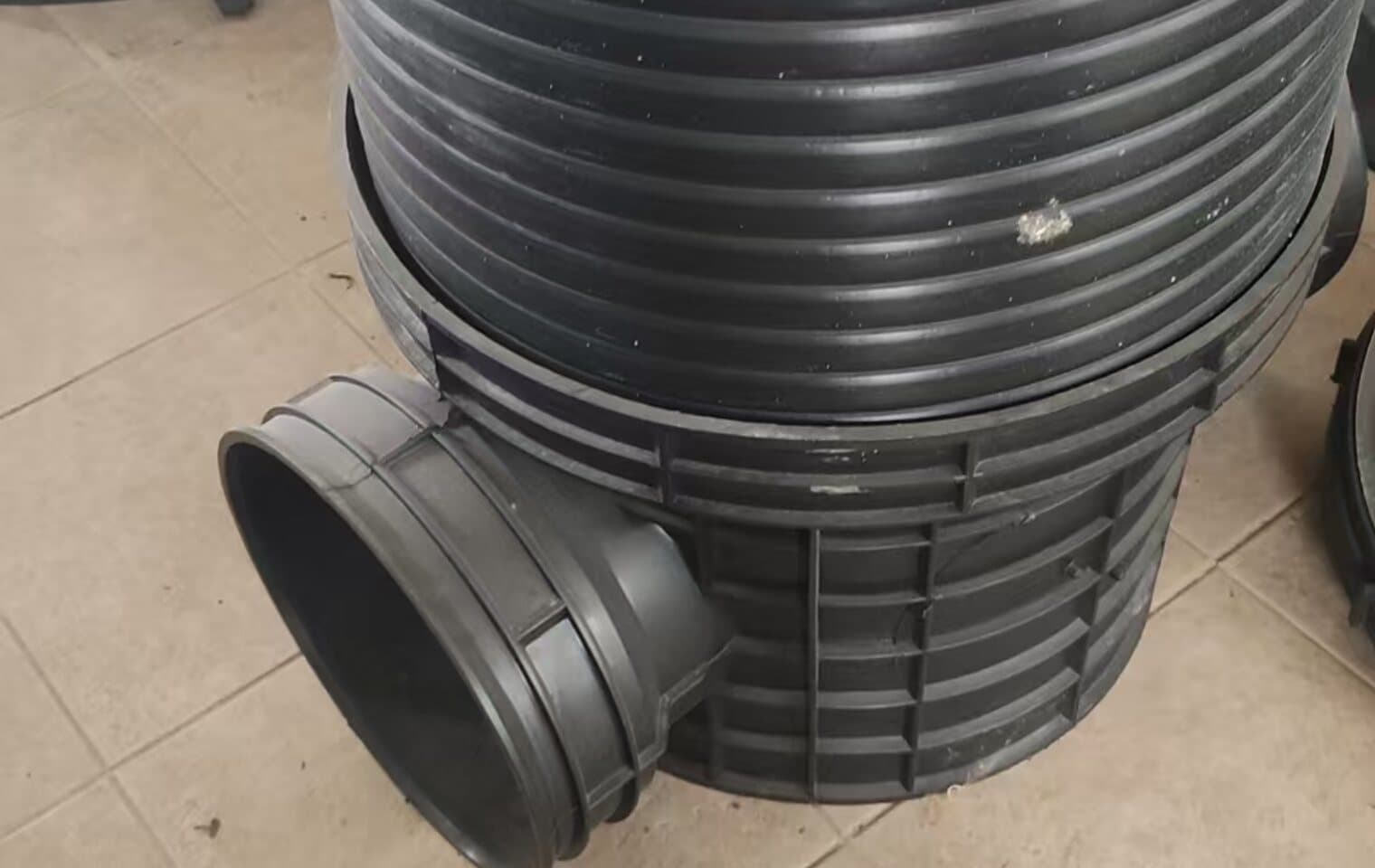 A ribbed HDPE inspection chamber with a moulded inlet, built up from sheet and pipe