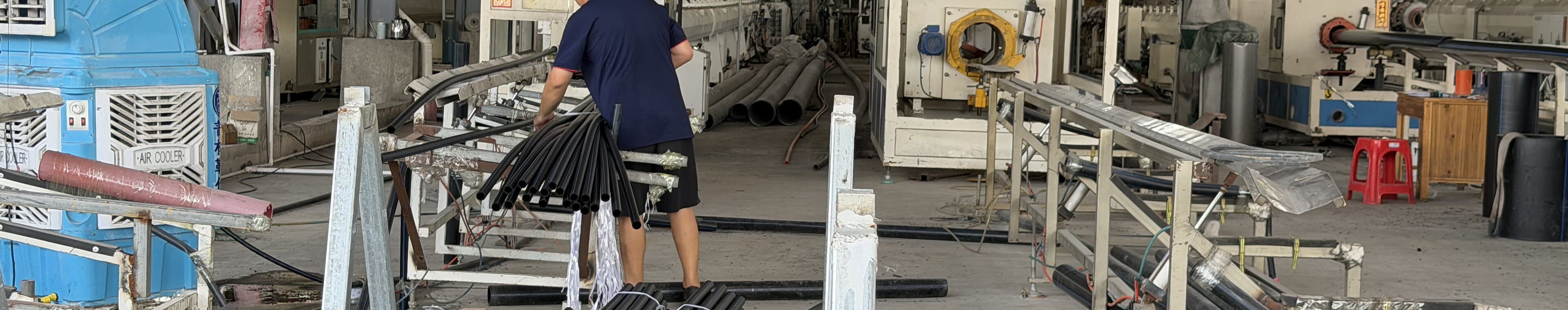 An operator moving coiled pipe through the plant