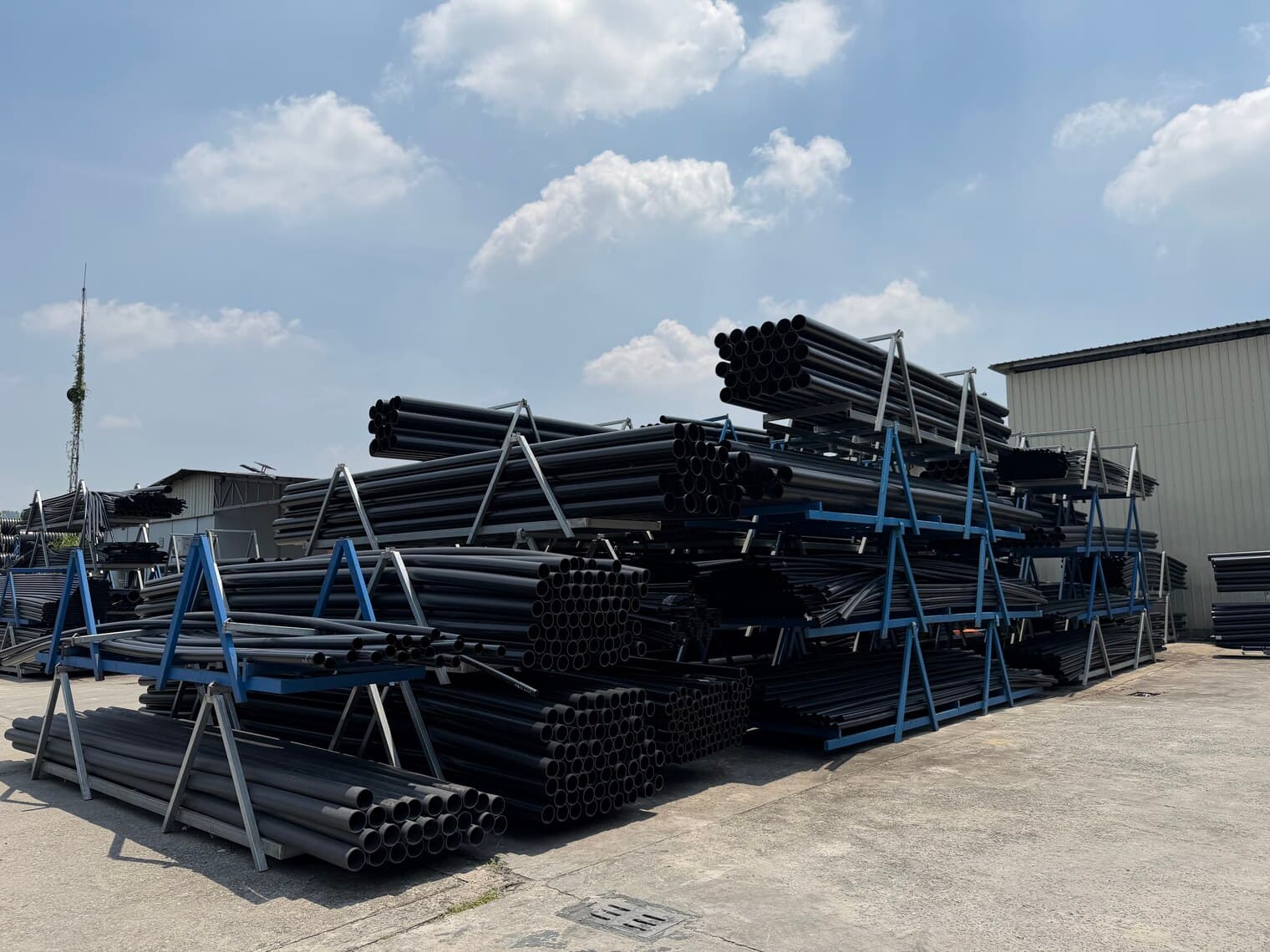 A panorama of the stock yard with rows of finished pipe under an open sky