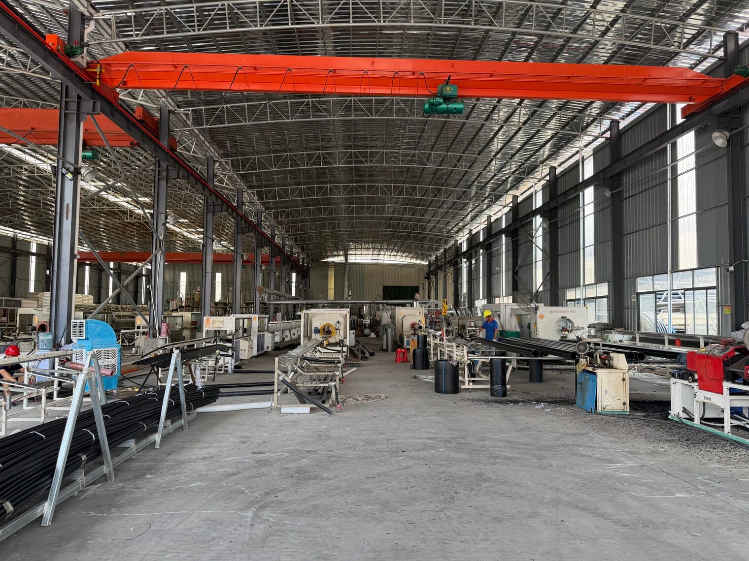 Looking the full length of the production hall past the lines and material stations