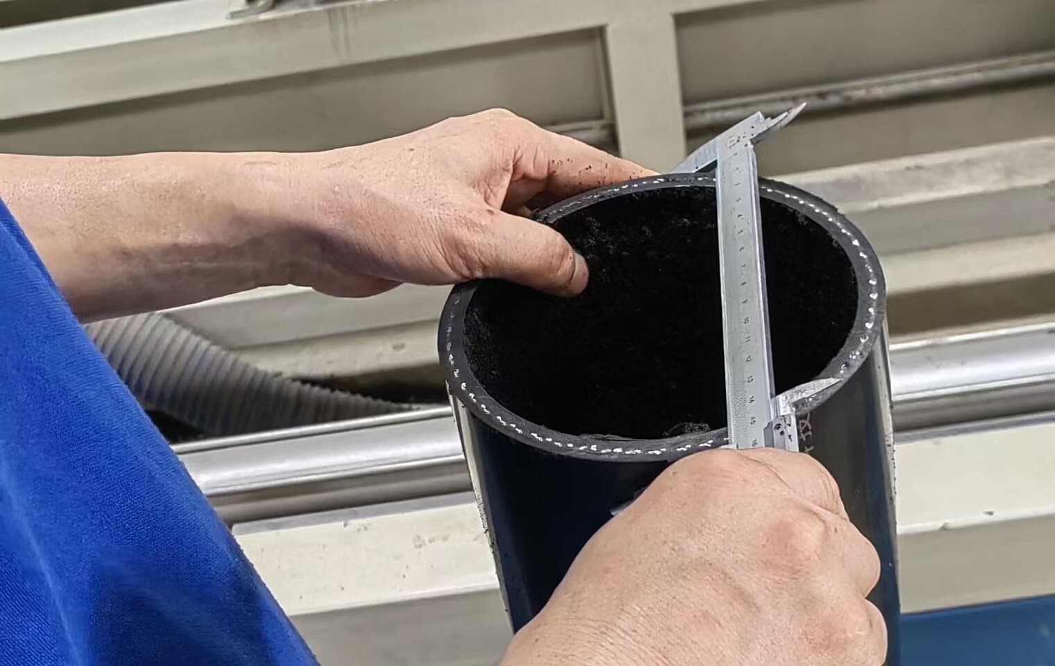 Wall thickness measured on a cut pipe sample with a vernier gauge